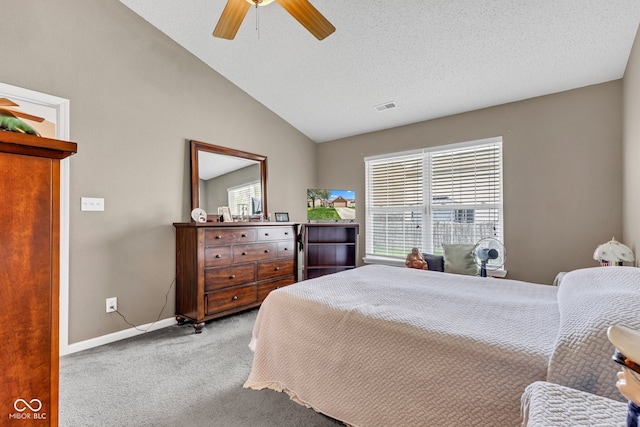 carpeted bedroom featuring lofted ceiling, baseboards, and a ceiling fan