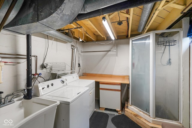 laundry room featuring independent washer and dryer, a sink, and laundry area
