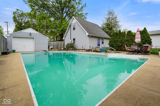 view of pool featuring an outbuilding, a fenced in pool, and fence