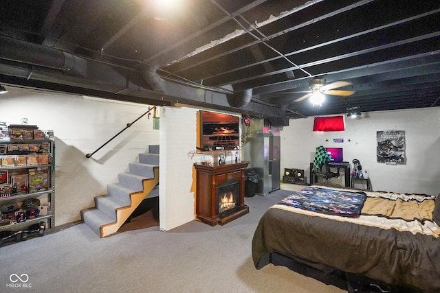 bedroom featuring a warm lit fireplace and carpet