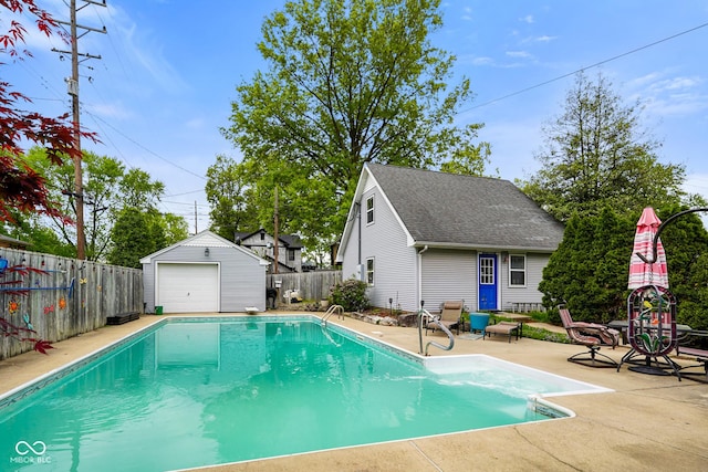 view of swimming pool with an outdoor structure, a fenced in pool, a fenced backyard, and a patio
