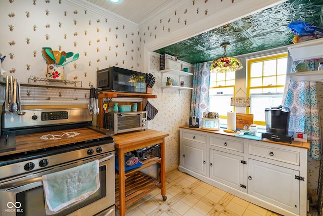kitchen with open shelves, wallpapered walls, and stainless steel range with electric cooktop