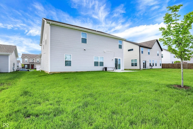 back of house featuring a lawn