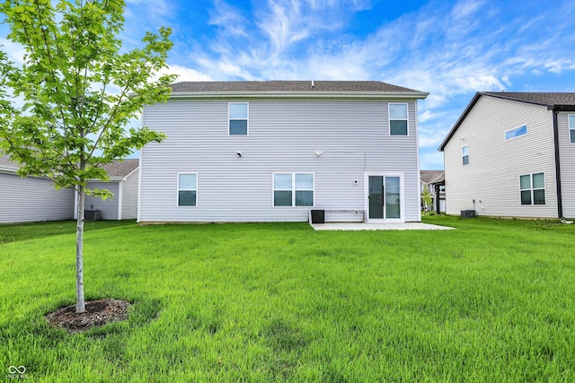 rear view of property featuring a patio area and a lawn