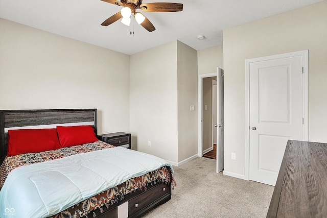 carpeted bedroom featuring baseboards and ceiling fan