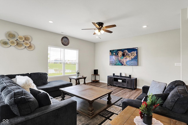 living room featuring a ceiling fan, baseboards, recessed lighting, and wood finished floors