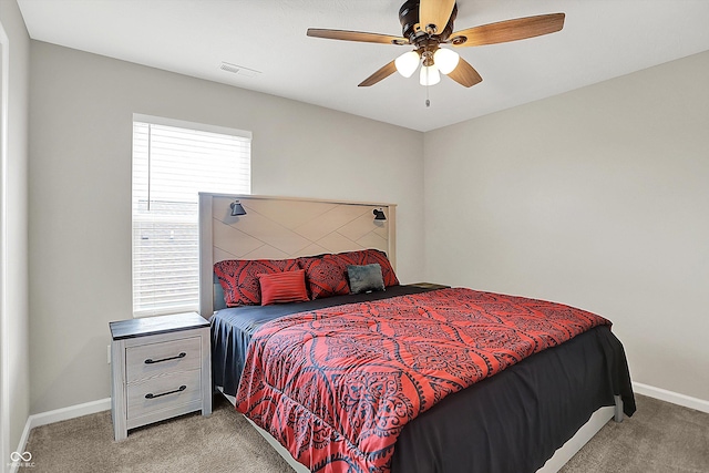 bedroom with baseboards, light carpet, visible vents, and a ceiling fan