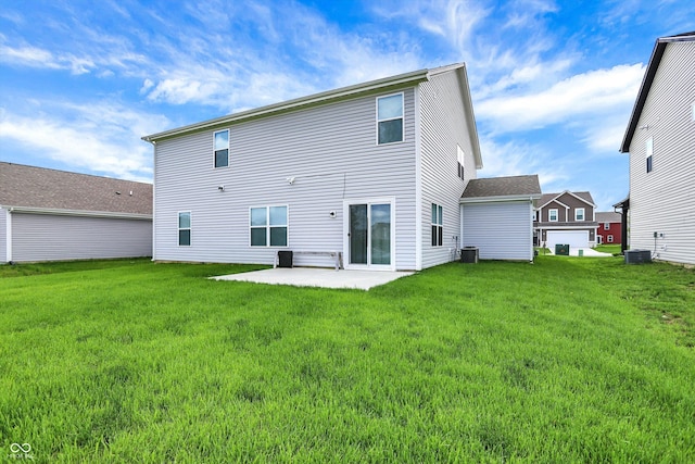 rear view of house featuring a patio, central AC, and a lawn