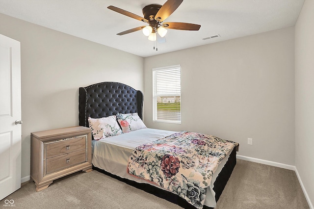 bedroom featuring light colored carpet, baseboards, ceiling fan, and visible vents