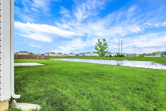view of yard featuring a water view and a residential view