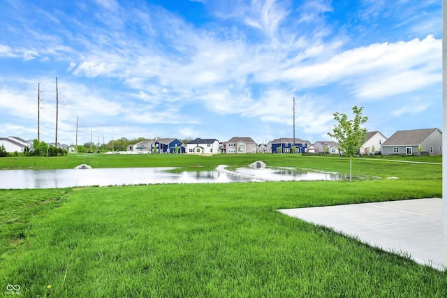 view of yard with a water view and a residential view