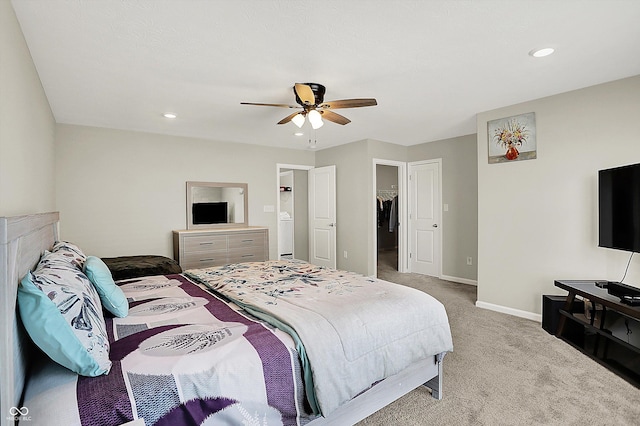 carpeted bedroom featuring baseboards, a ceiling fan, a spacious closet, and recessed lighting