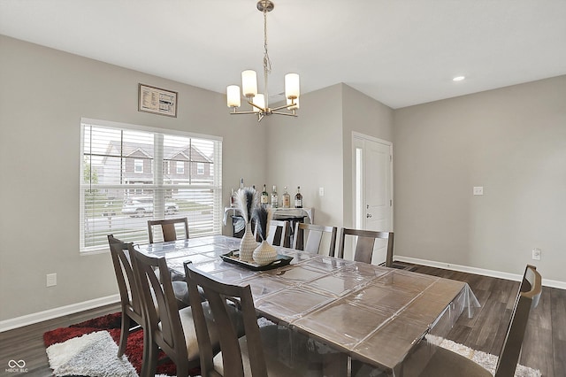 dining space with baseboards, a notable chandelier, dark wood finished floors, and recessed lighting