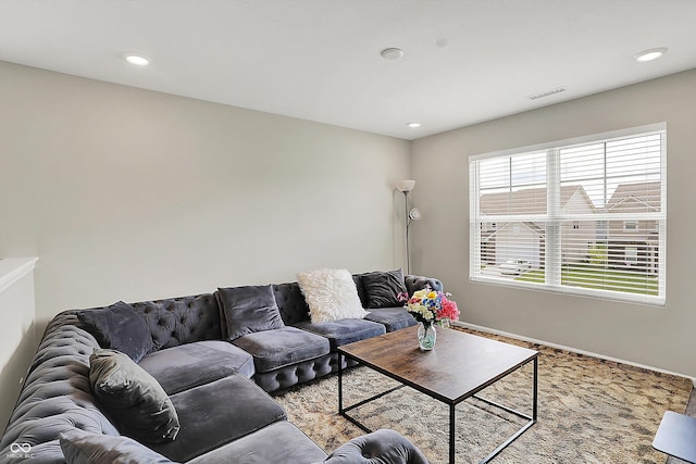 living area featuring baseboards, recessed lighting, and visible vents