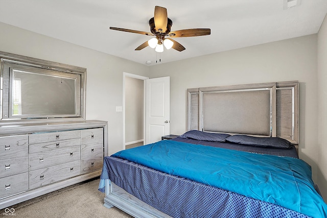 carpeted bedroom featuring baseboards and a ceiling fan