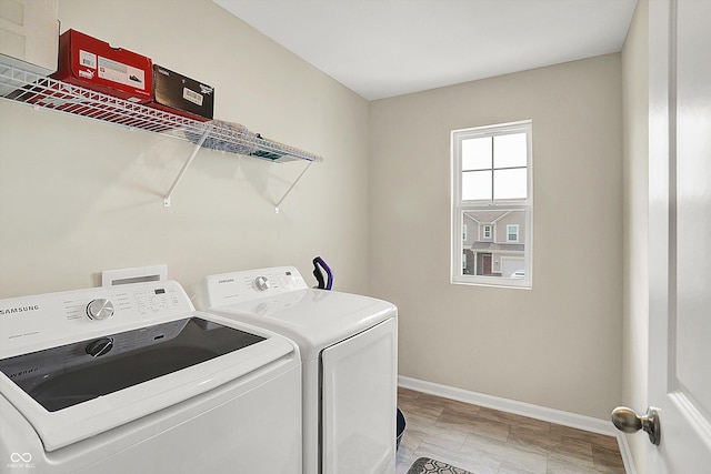 laundry room with baseboards, washing machine and dryer, and laundry area