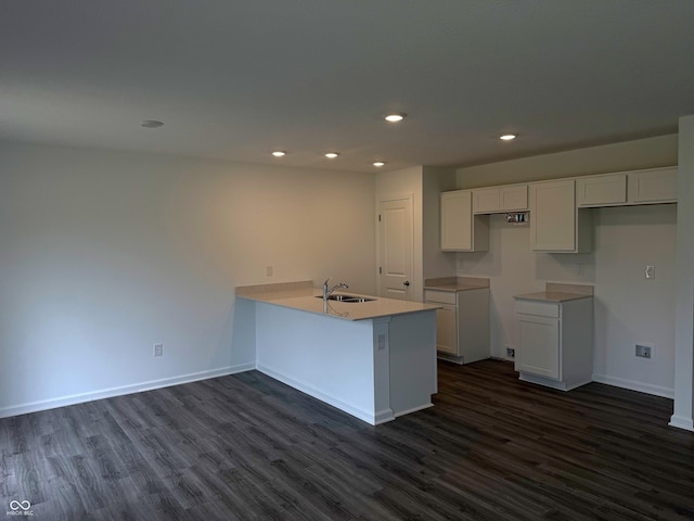 1400 Bluebonnet Pl, Shelbyville, IN 46176 - kitchen featuring dark wood-style floors, a peninsula, recessed lighting, white cabinets, and light countertops