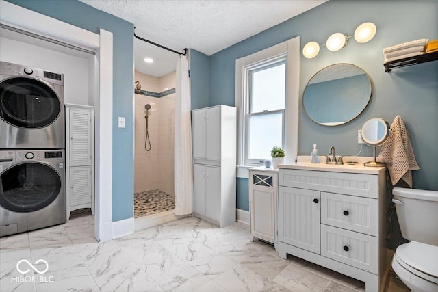 925 S State Ave, Indianapolis, IN 46203 - full bath with estacked washer and dryer, toilet, marble finish floors, a stall shower, and a textured ceiling