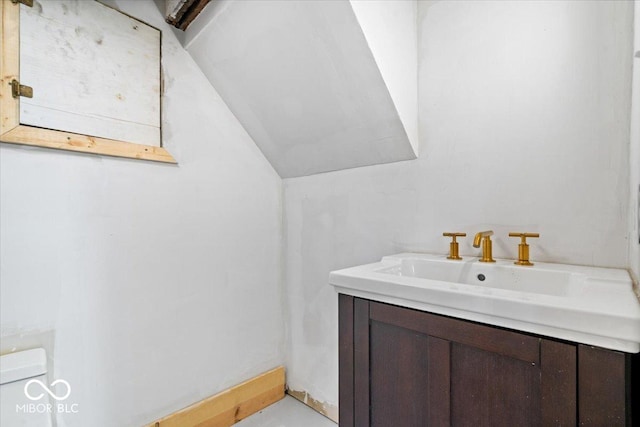 925 S State Ave, Indianapolis, IN 46203 - bathroom with vanity, vaulted ceiling, and toilet
