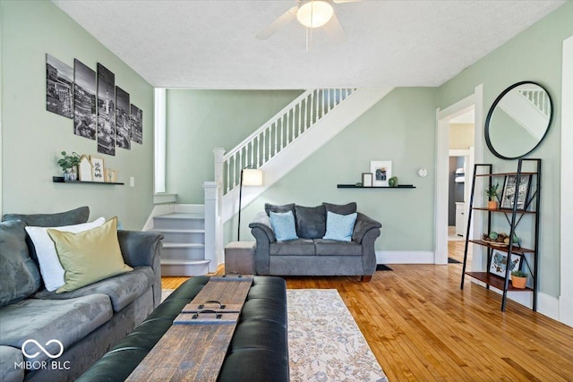 925 S State Ave, Indianapolis, IN 46203 - living area featuring stairway, wood finished floors, ceiling fan, a textured ceiling, and baseboards
