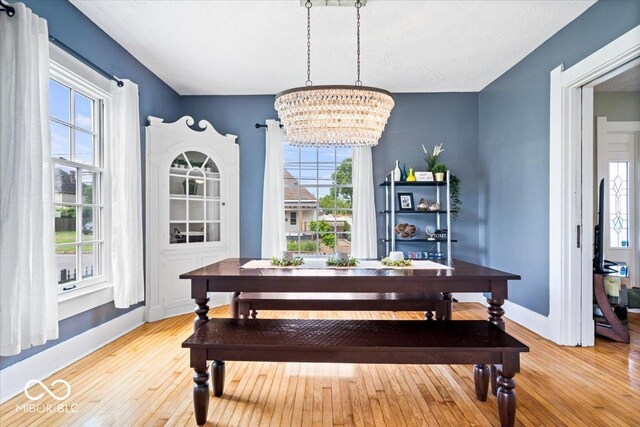 925 S State Ave, Indianapolis, IN 46203 - dining room with light wood-type flooring, baseboards, and a chandelier
