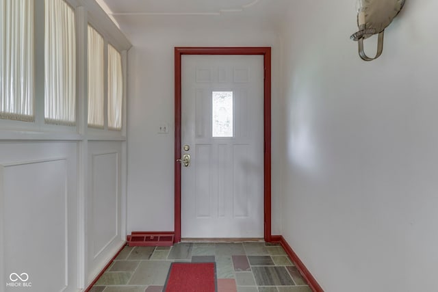 8903 Maple Hill Dr, Indianapolis, IN 46239 - doorway to outside featuring baseboards and stone finish flooring