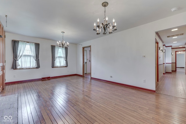 8903 Maple Hill Dr, Indianapolis, IN 46239 - unfurnished room featuring a chandelier, light wood-type flooring, and baseboards