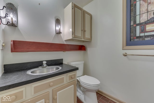 8903 Maple Hill Dr, Indianapolis, IN 46239 - bathroom with toilet, tile patterned floors, vanity, and baseboards