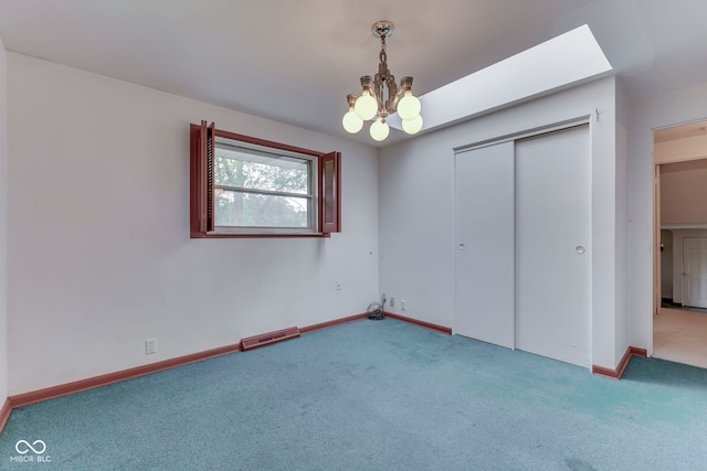 8903 Maple Hill Dr, Indianapolis, IN 46239 - unfurnished bedroom with carpet, a chandelier, baseboards, and a closet