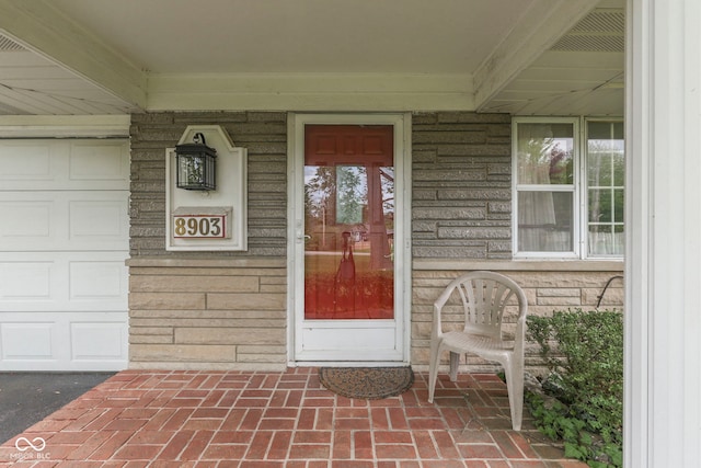 8903 Maple Hill Dr, Indianapolis, IN 46239 - view of exterior entry featuring covered porch and a garage