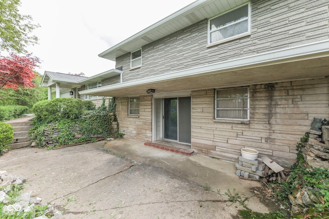 8903 Maple Hill Dr, Indianapolis, IN 46239 - rear view of house with a patio and stone siding