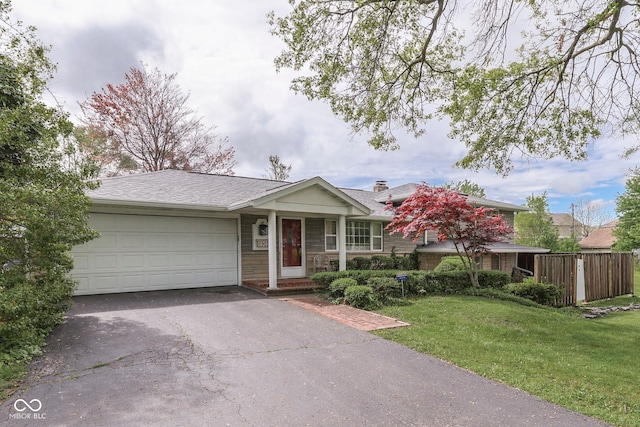 8903 Maple Hill Dr, Indianapolis, IN 46239 - single story home with asphalt driveway, an attached garage, a front lawn, and a chimney
