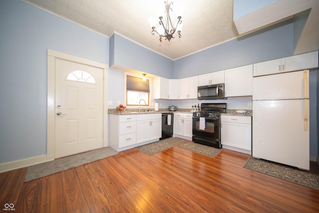 kitchen with an inviting chandelier, white cabinets, crown molding, dark wood finished floors, and black appliances