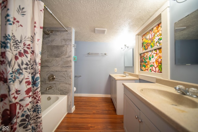 full bath featuring a sink, two vanities, shower / bath combination with curtain, and wood finished floors