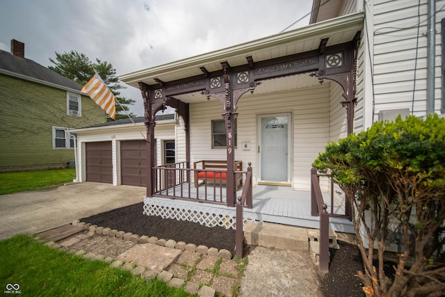 view of front of house featuring covered porch, concrete driveway, and a garage