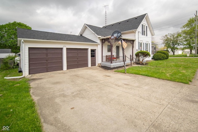 view of front of house with driveway, covered porch, an attached garage, a shingled roof, and a front lawn