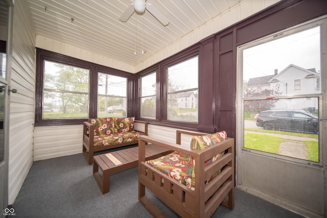 sunroom / solarium featuring a ceiling fan