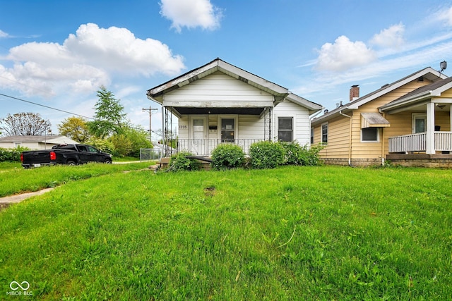 1235 N Grant Ave, Indianapolis, IN 46201 - view of front of home featuring a porch and a front lawn