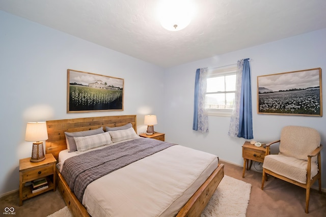 bedroom with light carpet and baseboards