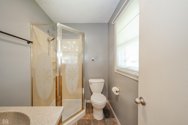 full bath featuring vanity, toilet, baseboards, and a shower stall