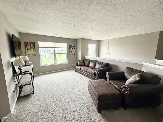 living area featuring a textured ceiling, visible vents, baseboards, and carpet floors