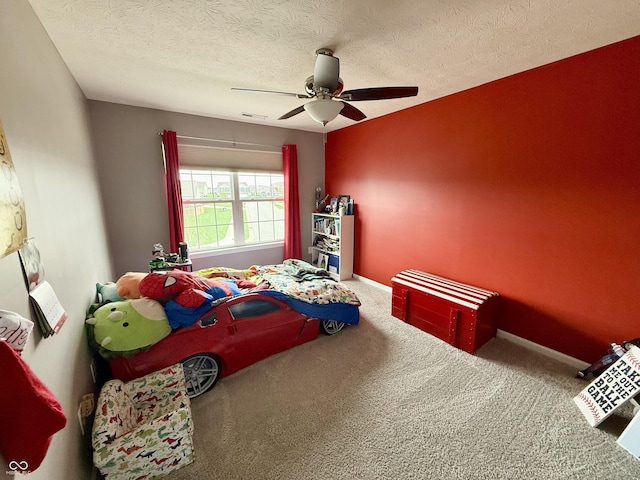 bedroom featuring a textured ceiling, visible vents, ceiling fan, and carpet