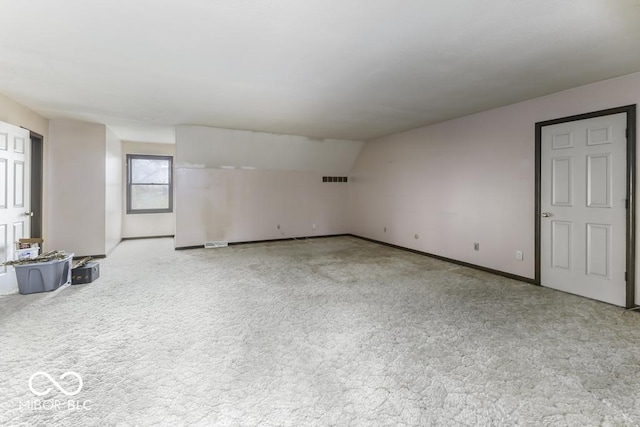 3134 W Hickory Woods Dr, Greenfield, IN 46140 - unfurnished living room with light carpet, baseboards, and vaulted ceiling