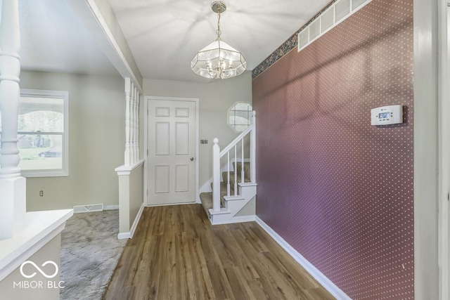 3134 W Hickory Woods Dr, Greenfield, IN 46140 - foyer with a chandelier, wood finished floors, baseboards, stairway, and wallpapered walls