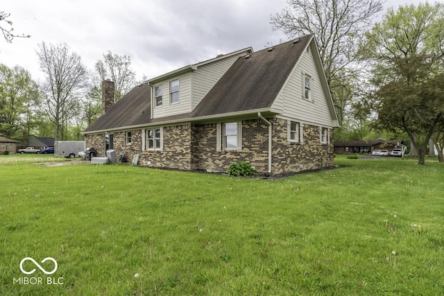 3134 W Hickory Woods Dr, Greenfield, IN 46140 - back of house with a lawn, a chimney, brick siding, and a shingled roof