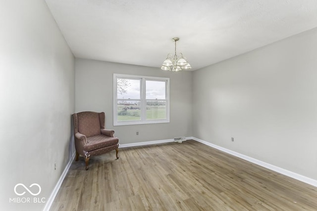 3134 W Hickory Woods Dr, Greenfield, IN 46140 - unfurnished room with a chandelier, light wood finished floors, and baseboards