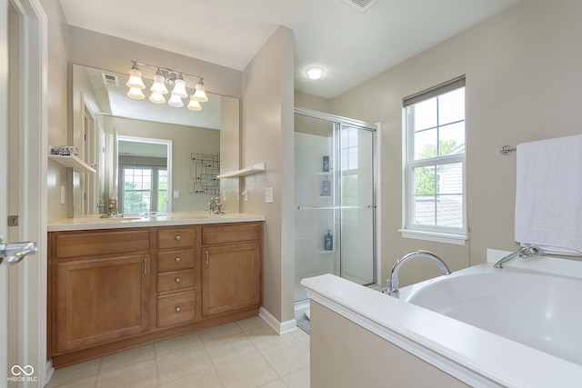 6839 Powder Dr, Indianapolis, IN 46259 - bathroom featuring a shower stall, double vanity, a garden tub, baseboards, and tile patterned flooring