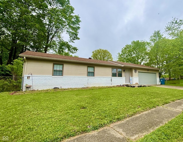 ranch-style home with a front lawn, brick siding, driveway, and a garage