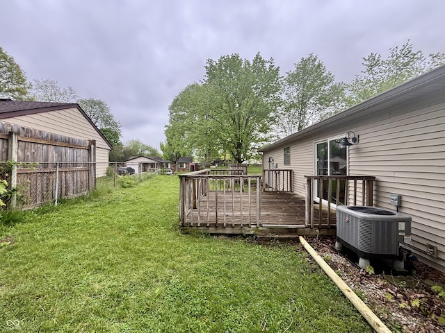 view of yard featuring central AC unit, fence, and a deck