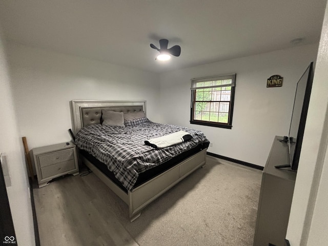 bedroom with baseboards, ceiling fan, and wood finished floors